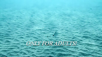 Young Women Swim Without Bathing Suits In The Ocean Off Tenerife